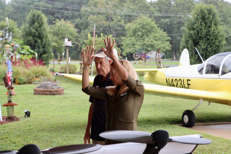 Heather Chirtea, right, demonstrates how her Black Fly electric flying car handles in the sky to Bob Mench, 90. Mench got his pilot’s license at age 79.